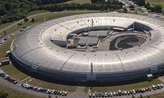 Aerial view of a grey ring shaped building.