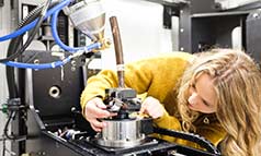 A female researcher operating X-ray machinery