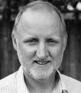 Black and white profile of a man smiling for the camera