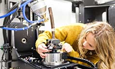 A female researcher operating X-ray machinery